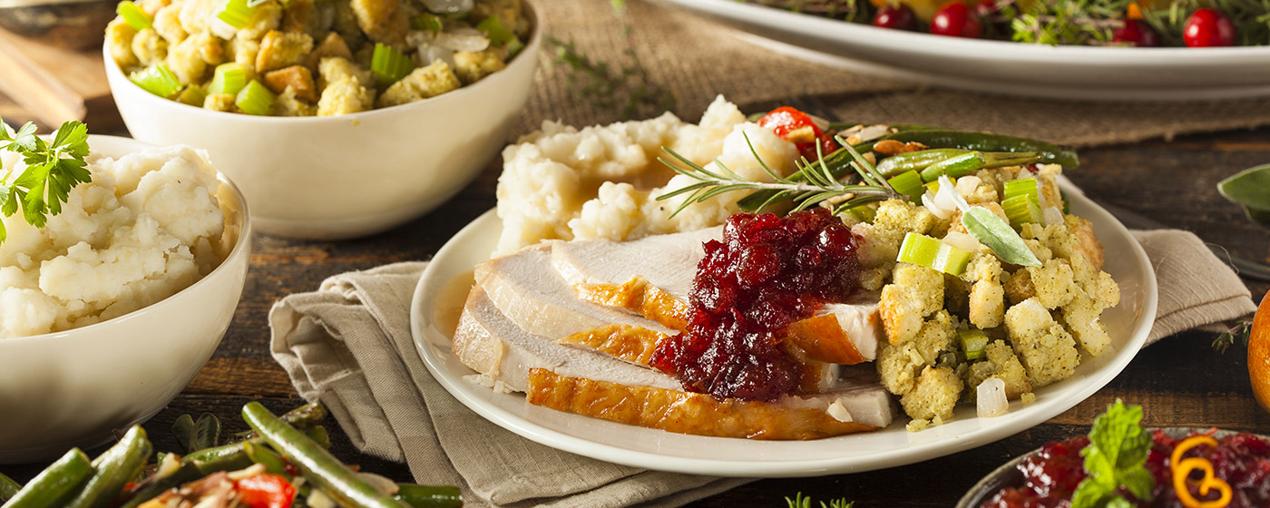 Image of plate of holiday feast with turkey, cranberry sauce, mashed potatoes and gravy