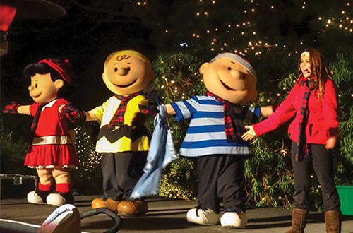 Peanuts characters dancing with employee
