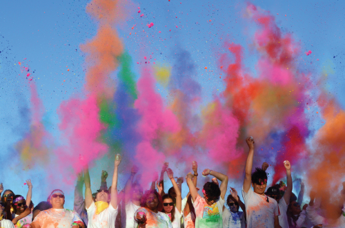 group of kids tossing colored powder
