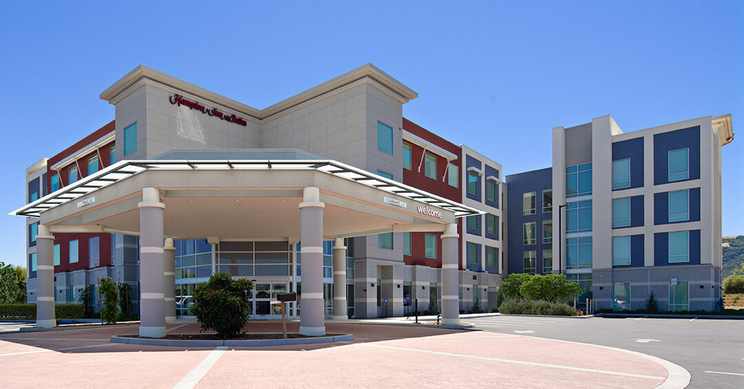 Hampton Inn hotel painted beige, red, and blue