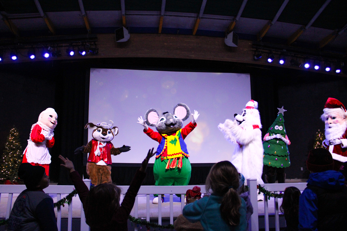 Rudy the Polar Bear dancing with Mrs. Claus and Skitter the Mouse on stage at North Pole Nights