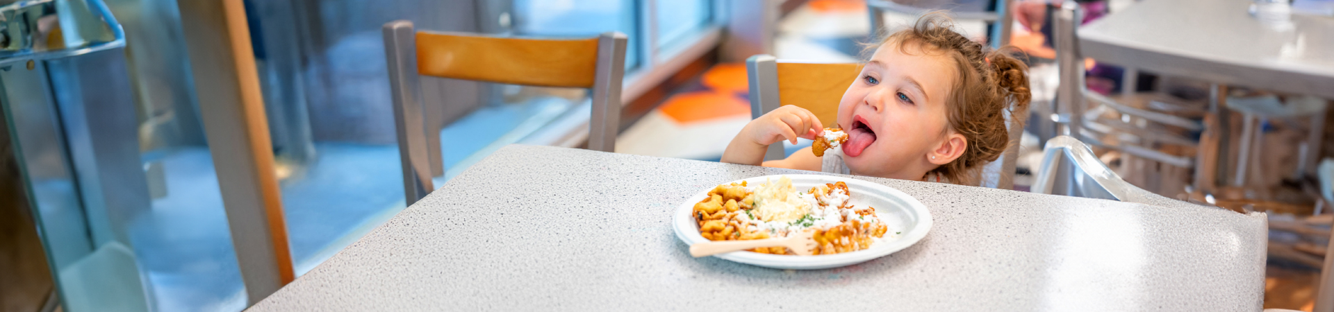 Little girl eating garlic funnel cake