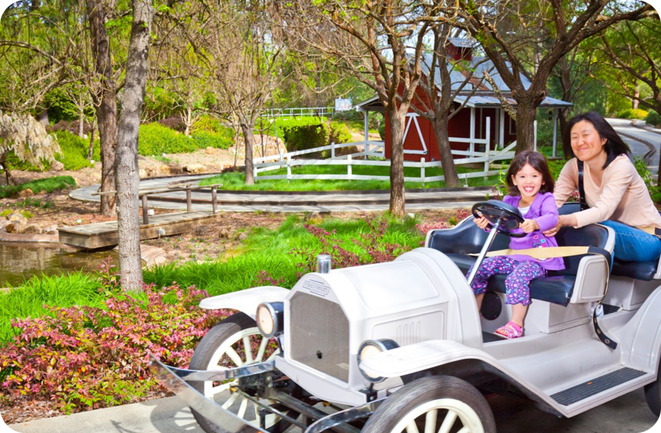 Mother in tan shirt and blue pants riding the South County Backroads ride with her daughter wearing an all purple outfit