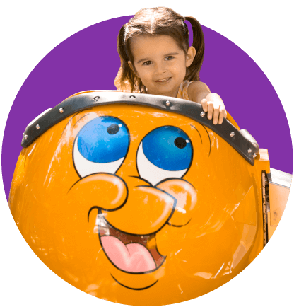 Little girl with pigtails smiling while on Bulgy the Goldfish ride.