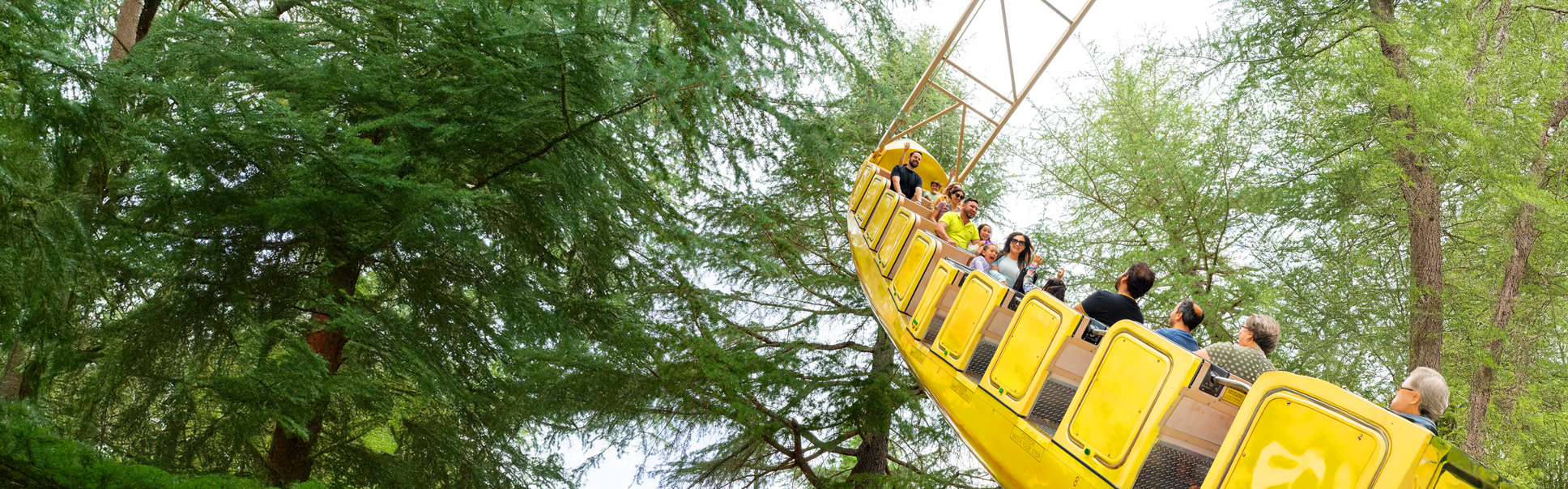 Guests smiling while riding the Banana Split ride