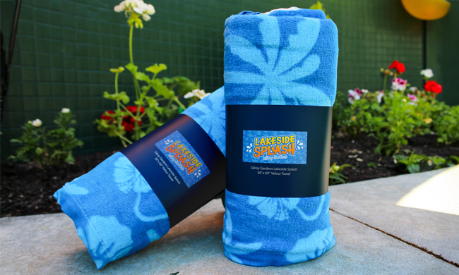 Blue towels with palm trees and flowers imprinted on it