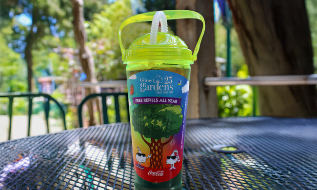 Yellow soda cup with a circus tree graphic on it