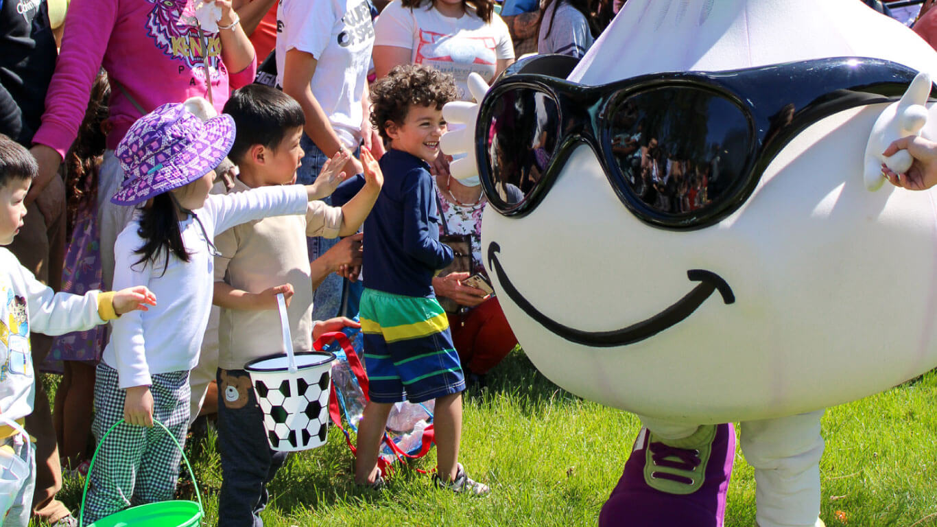Children smiling with excitement seeing Gil at the Easter event