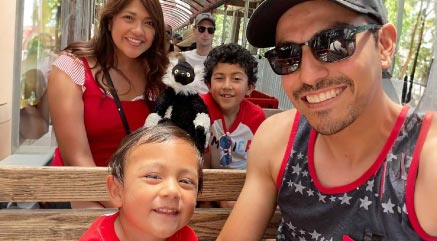Family of four in patriotic attire smiling while on the Coyote & Redwood Railroad ride at the Memorial Day Celebration