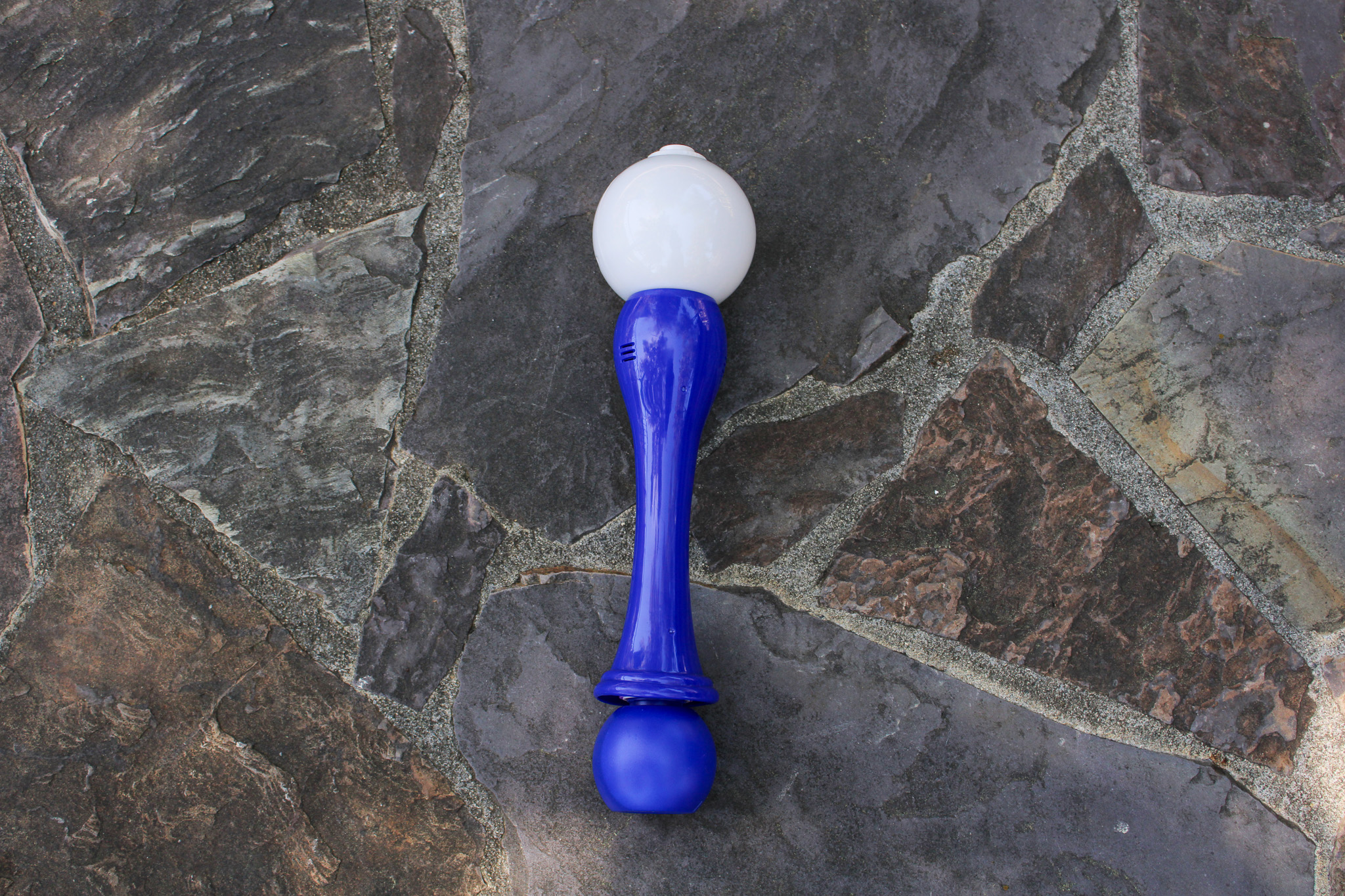 Blue bubble wand on grey rock