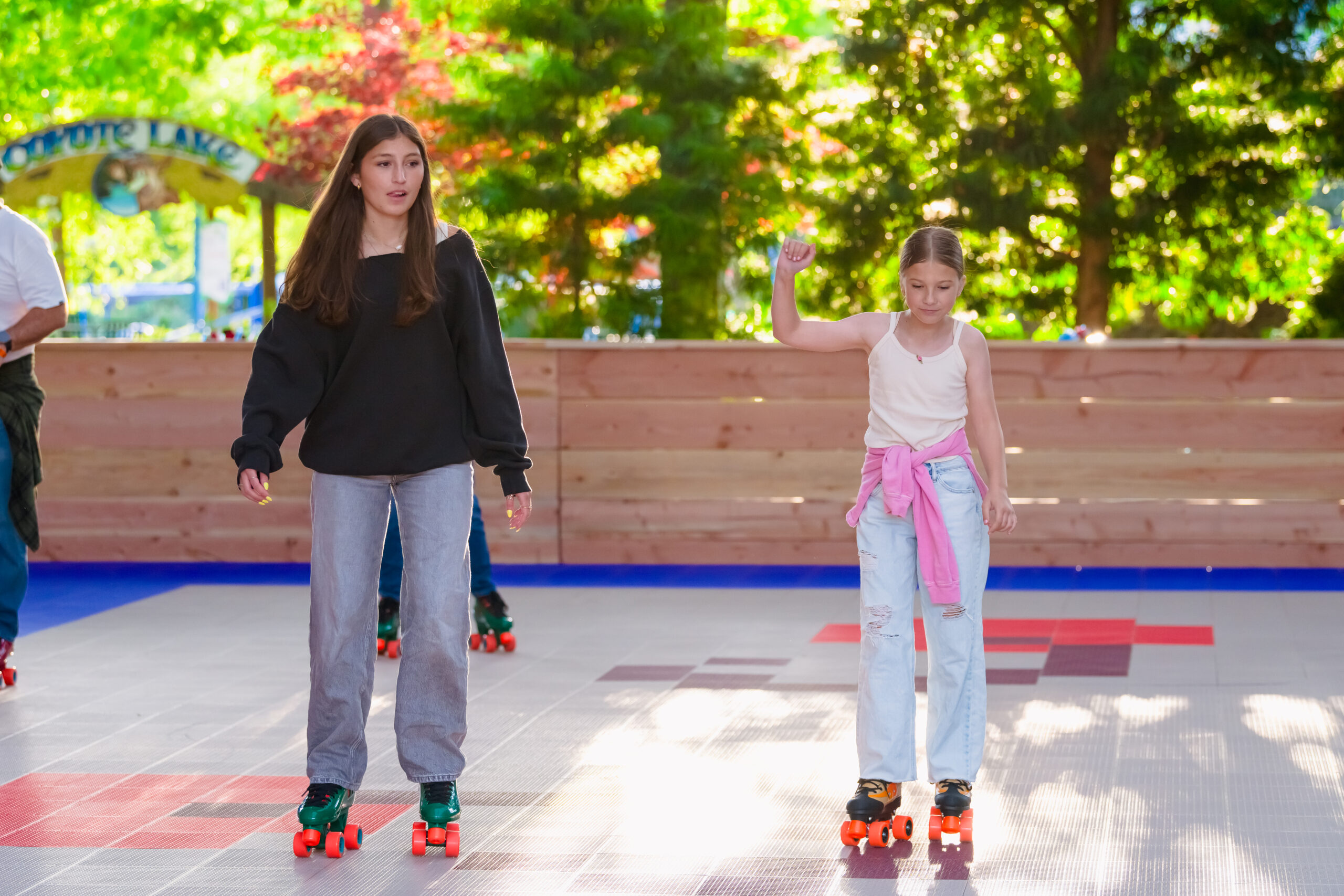 Two girls roller skating at the Cherrydome roller rink.