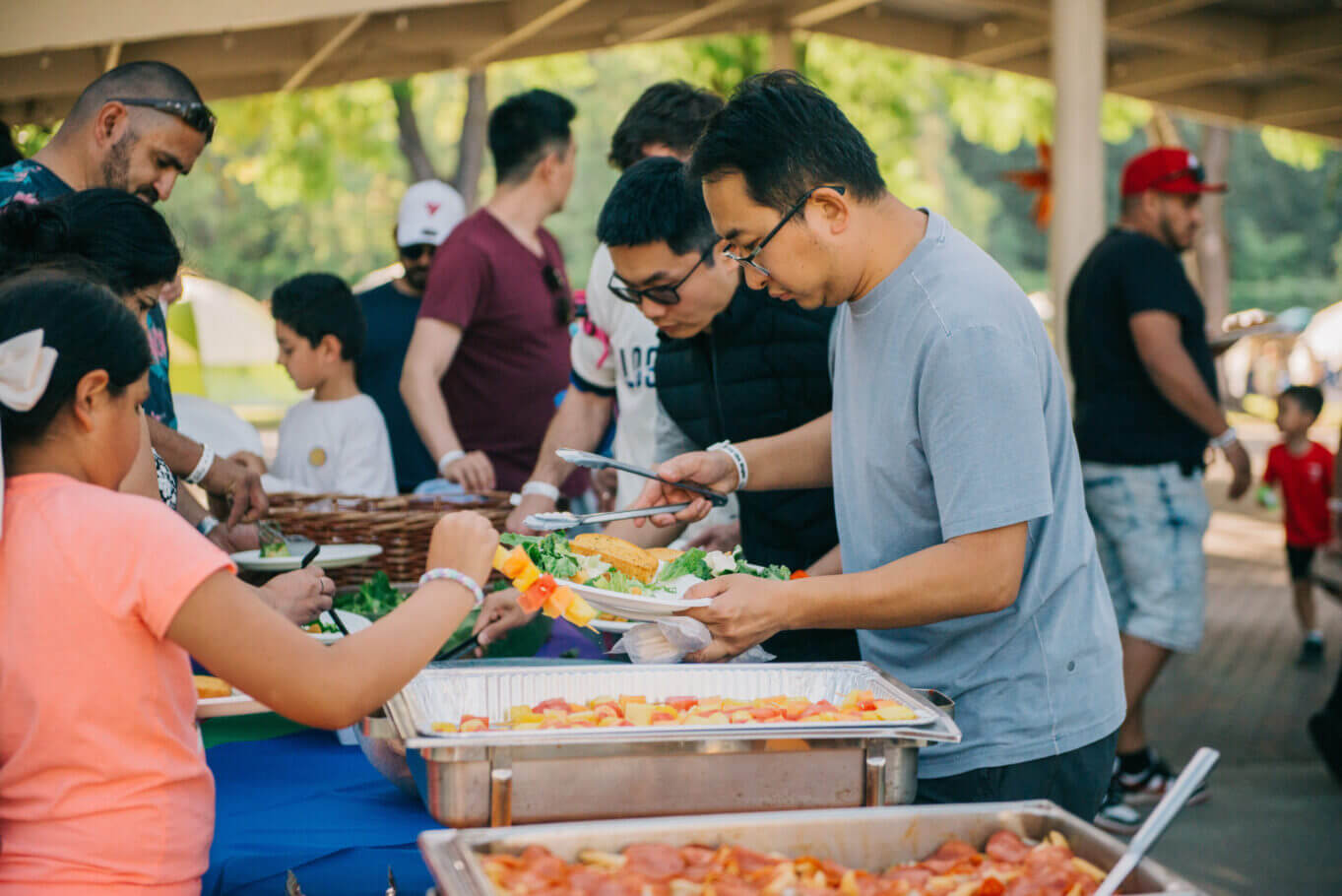 Families getting food from the camp night buffet