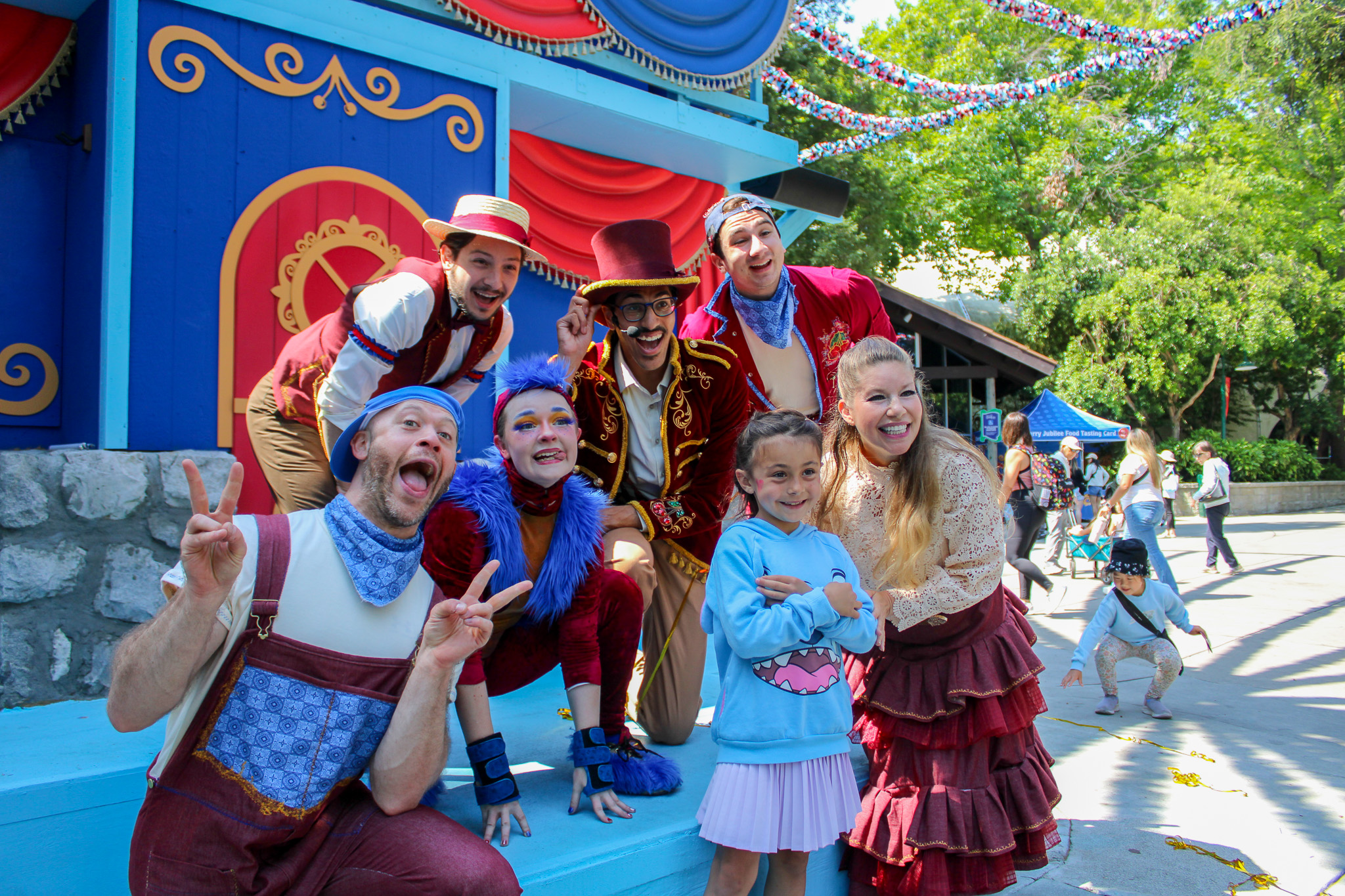 Child wearing a blue shirt while having their photo taken with the Merry Cherry Bunch.