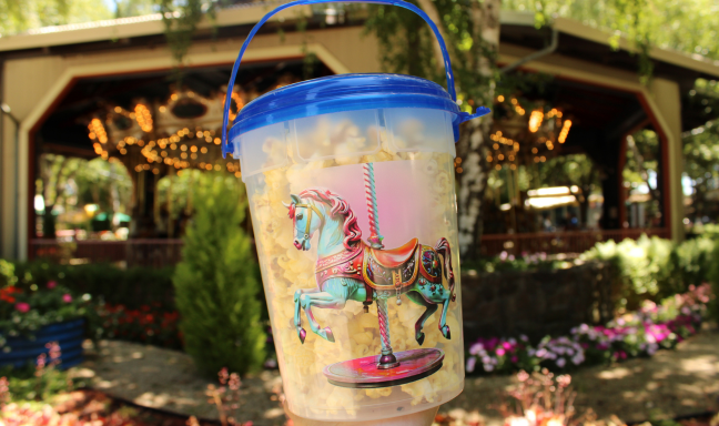 Carousel horse image on a clear popcorn bucket with a blue lid